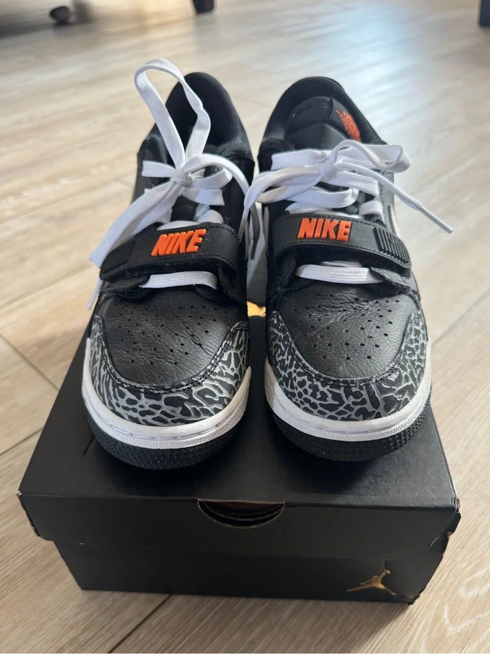 Nike Men’s Black and White Sneakers with Orange Logo Accent